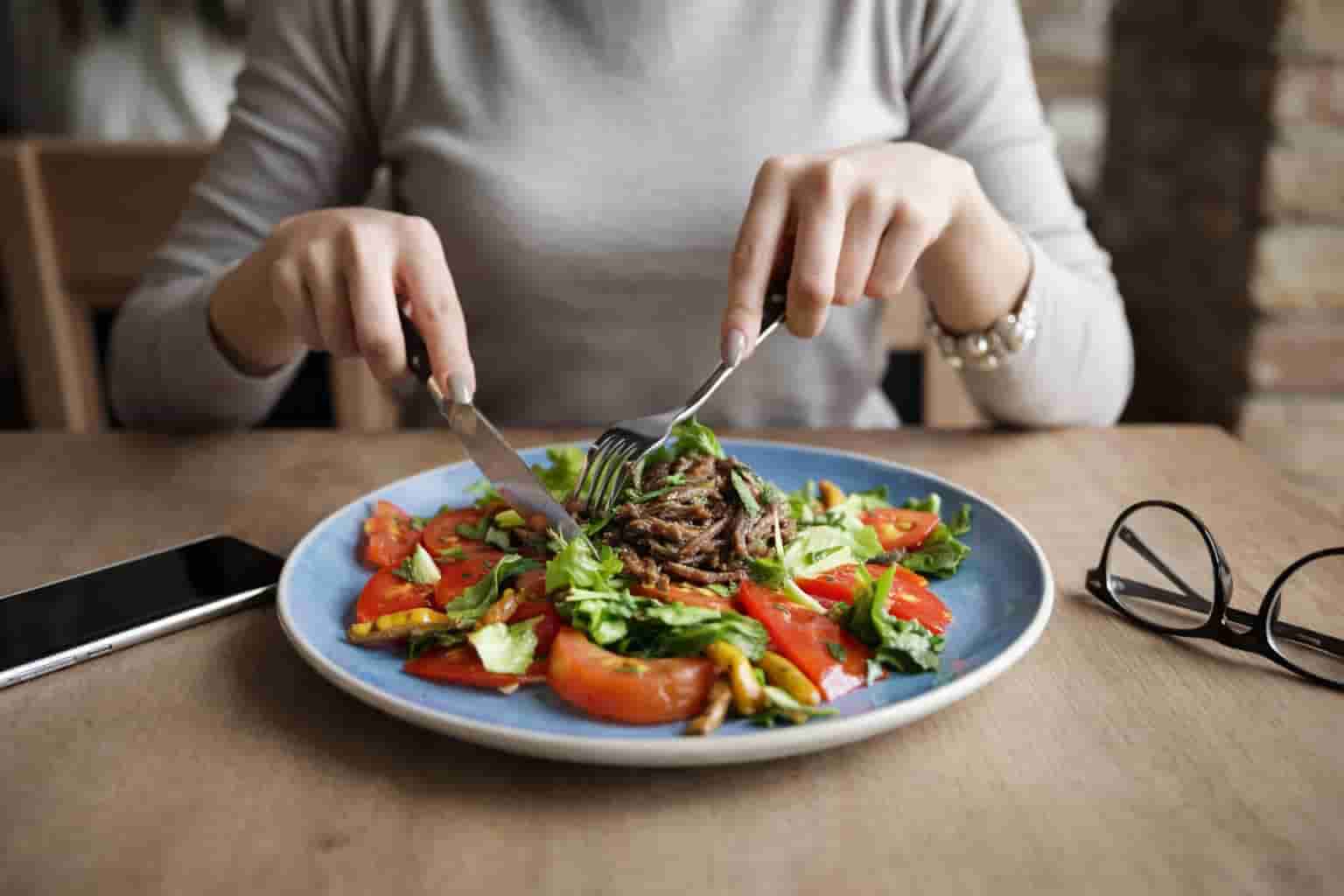 A healthy person enjoying a meal comfortably after digestive relief